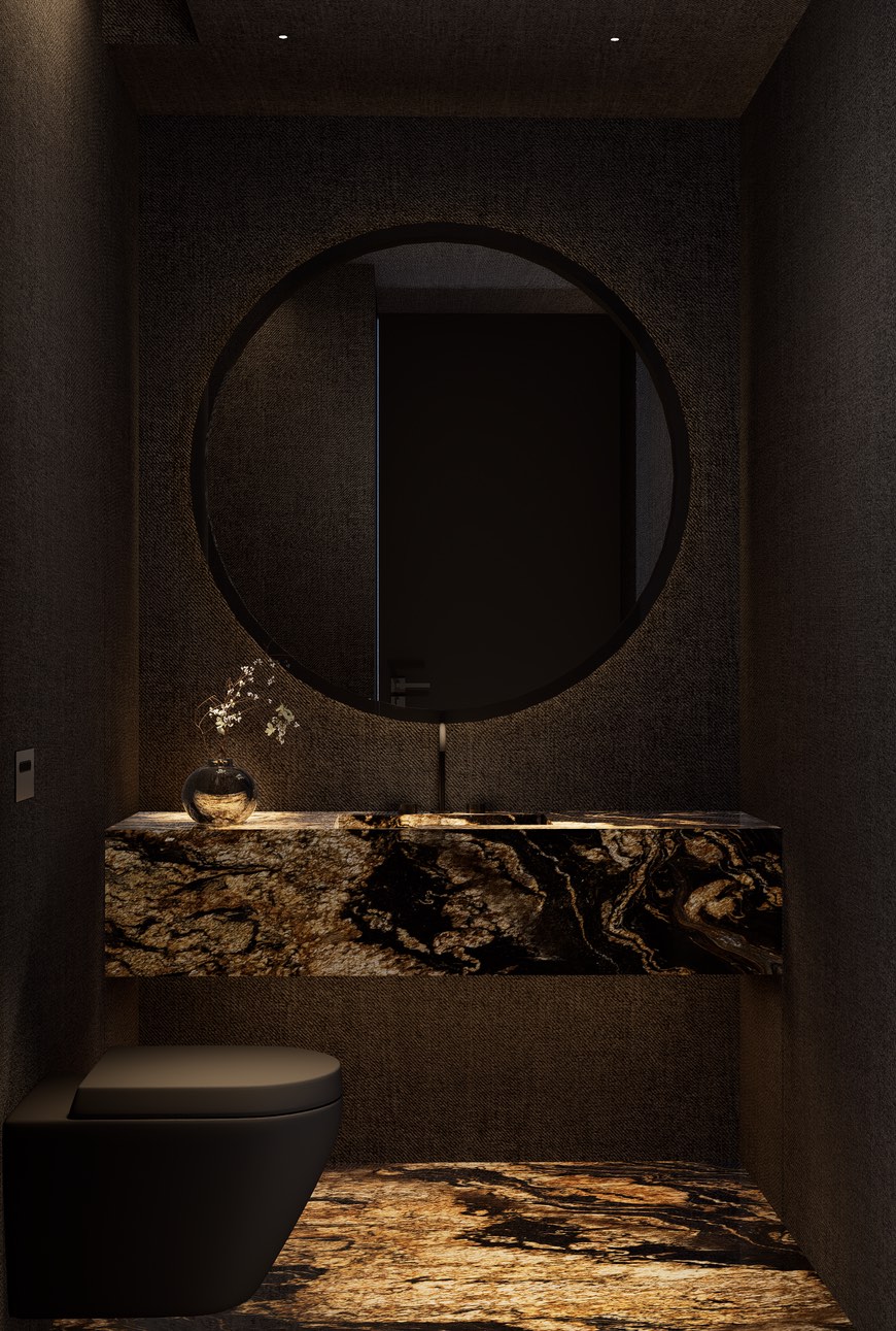Toilette oscuro con mesada de piedra veteada en tonos dorados, espejo redondo y paredes texturadas
